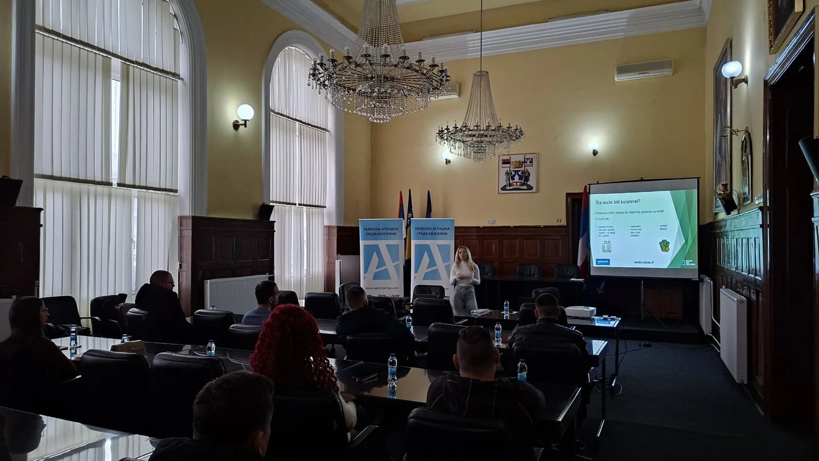 Predavačica uz prezentaciju i banere Razvojne agencije Grada Bijeljina, pred učesnicima edukacije za lokalne preduzetnike.