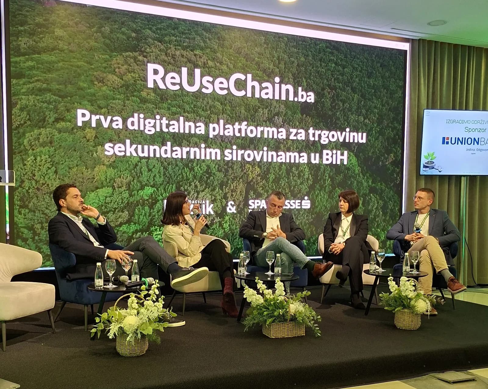 Panelisti sjede pred ekranom s prikazom platforme ReUseChain.ba.